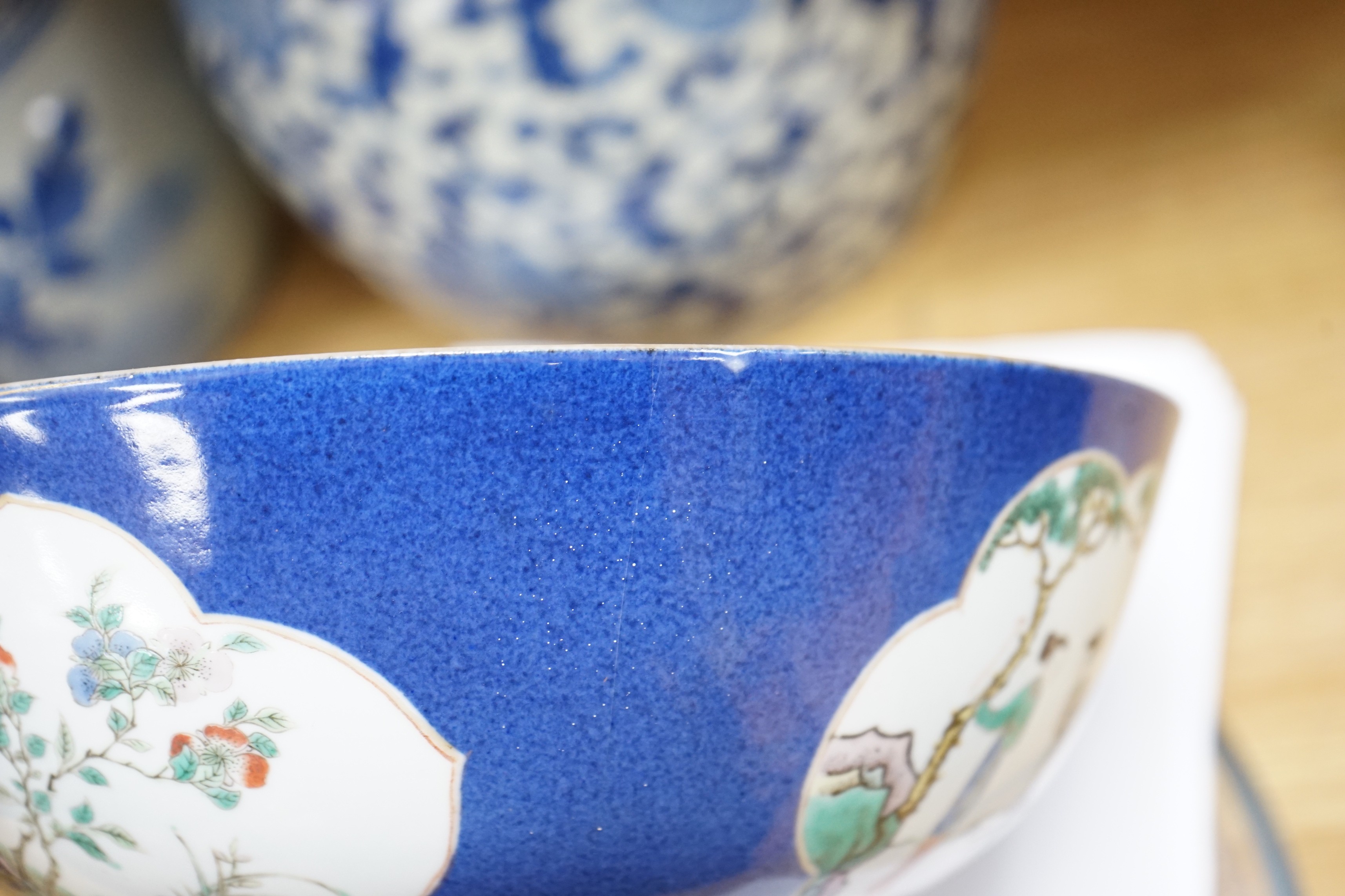 A 19th century Chinese famille verte powder blue bowl, 26cm diameter, wood stand